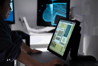 Radiology technician viewing mammogram screen during scan at Penn Medicine